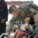 U.S. Soldiers, civilians deliver wheelchairs to Iraqi children in need.