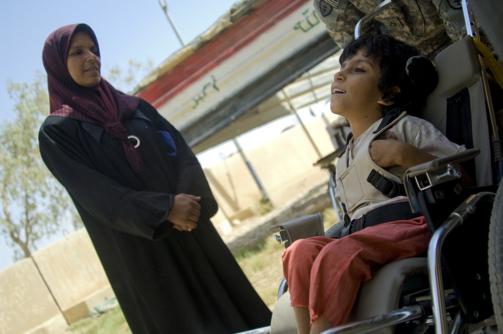 U.S. Soldiers, civilians deliver wheelchairs to Iraqi children in need.