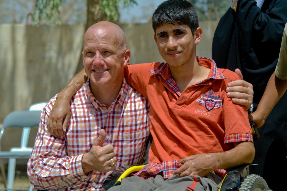 U.S. Soldiers, civilians deliver wheelchairs to Iraqi children in need.