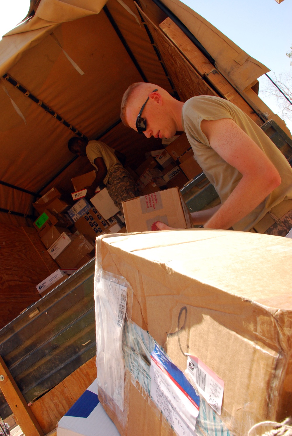 Victory Base Complex mail clerks deliver smiles and packages to service members