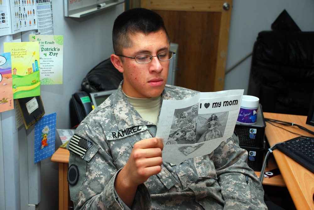 Victory Base Complex mail clerks deliver smiles and packages to service members