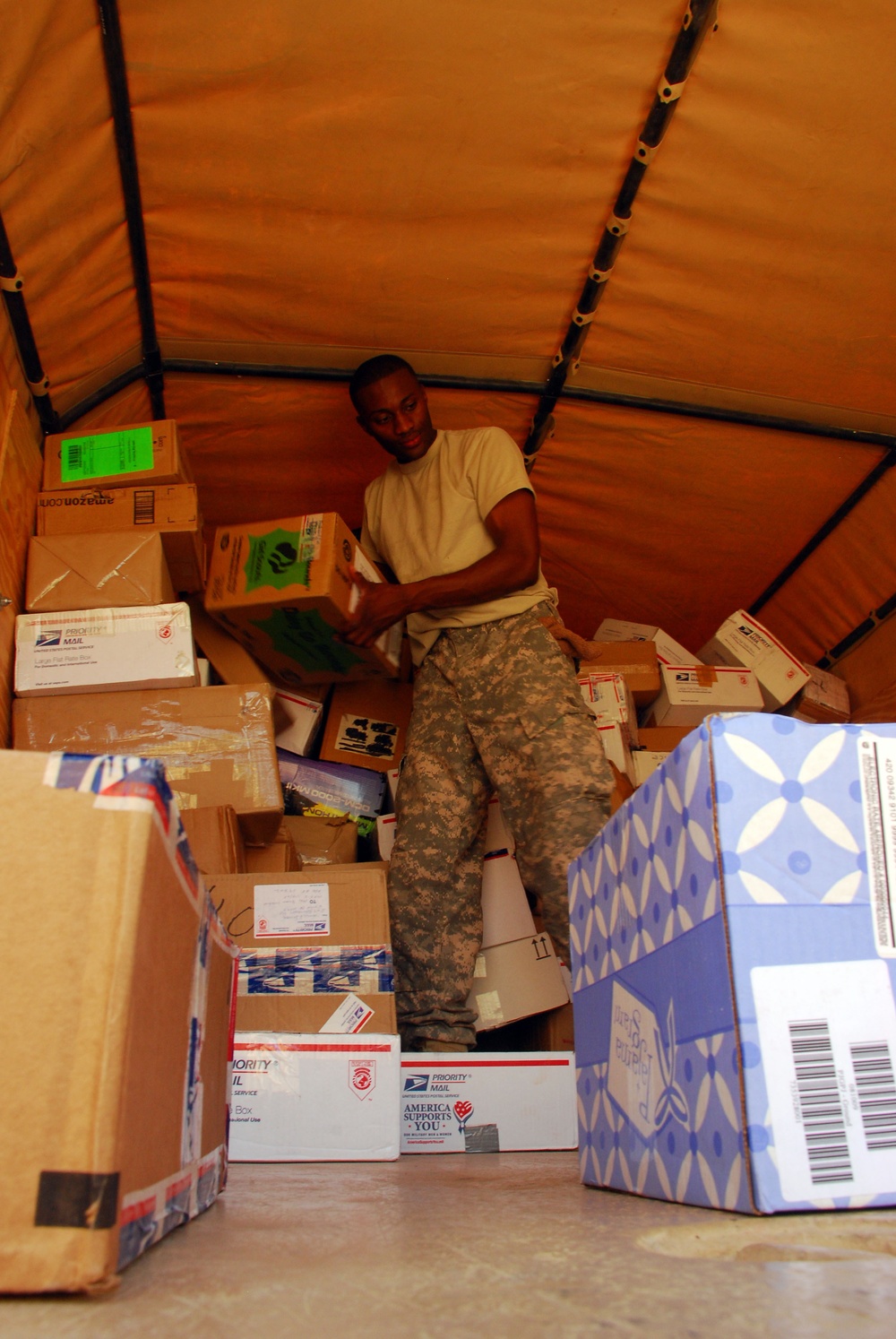 Victory Base Complex mail clerks deliver smiles and packages to service members