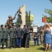 Retired Maj. Gen. Charles Rosenfeld, former Assistant Adjutant General, Oregon Army National Guard, presents a drawing of Pfc. Thomas Tucker to his parents during a dedication of a veteran's memorial in Madras, Ore., Aug. 23. Tucker, was killed in Iraq, J