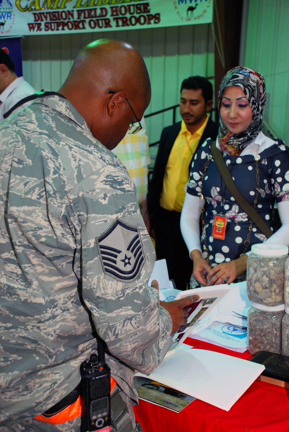 Service members work with Iraqi businesses
