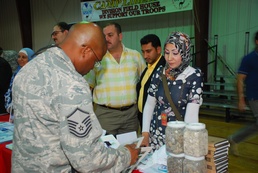 Service members work with Iraqi businesses