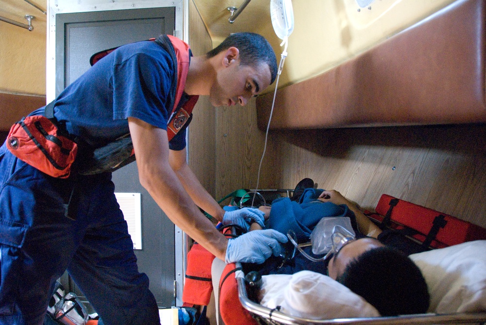 Coast Guard Boatswain Mate Examines Medevaced Passenger From Cruise Ship