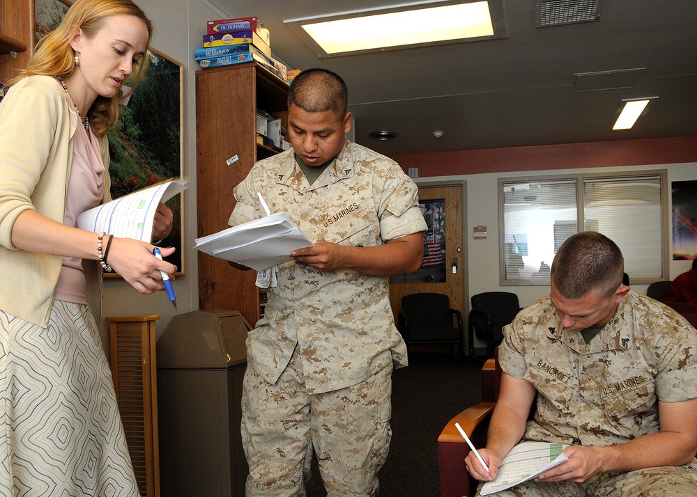 Pfc. Bronson Bell and Cpl. Ryan Bancroft, both assigned to the Naval Medical Center Portsmouth Wounded Warrior Battalion, sign up for the Veteran's Individual Training Assistance Link program with Dawn Espley, a VITAL program coach. The program provides w