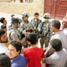 Soldiers hand out packages to locals