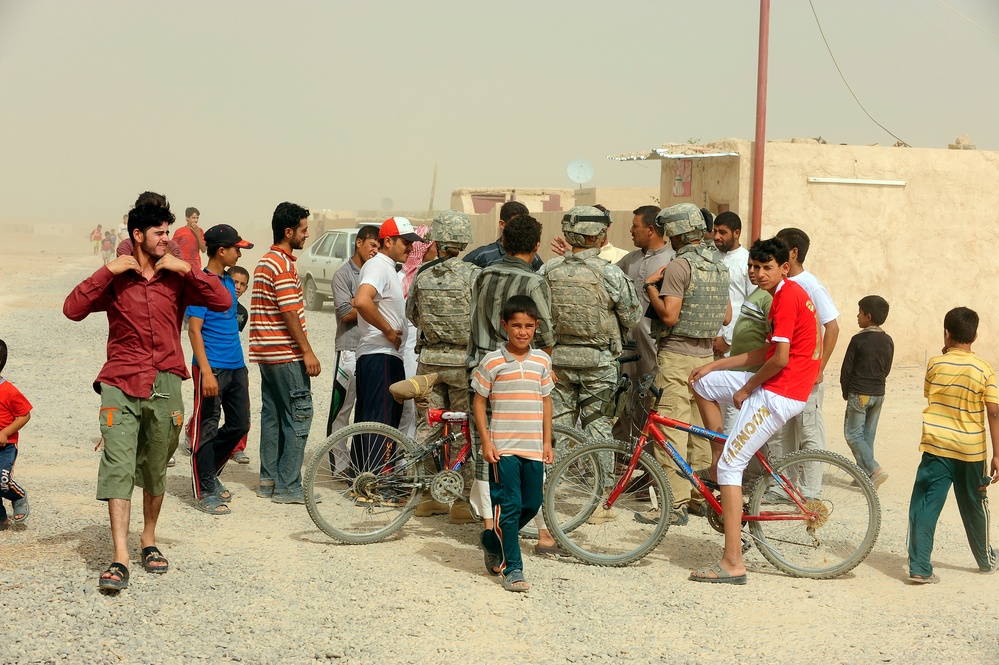 Soldiers hand out packages to locals