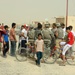Soldiers hand out packages to locals