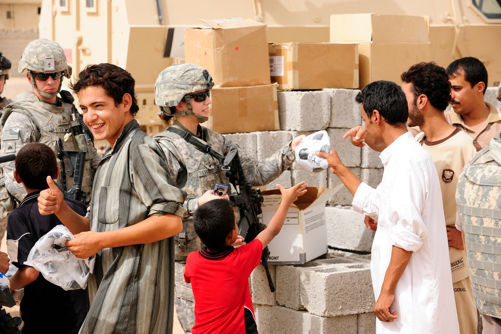 Soldiers hand out packages to locals