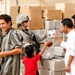 Soldiers hand out packages to locals