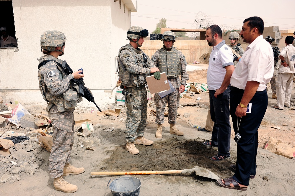 Soldiers hand out packages to locals