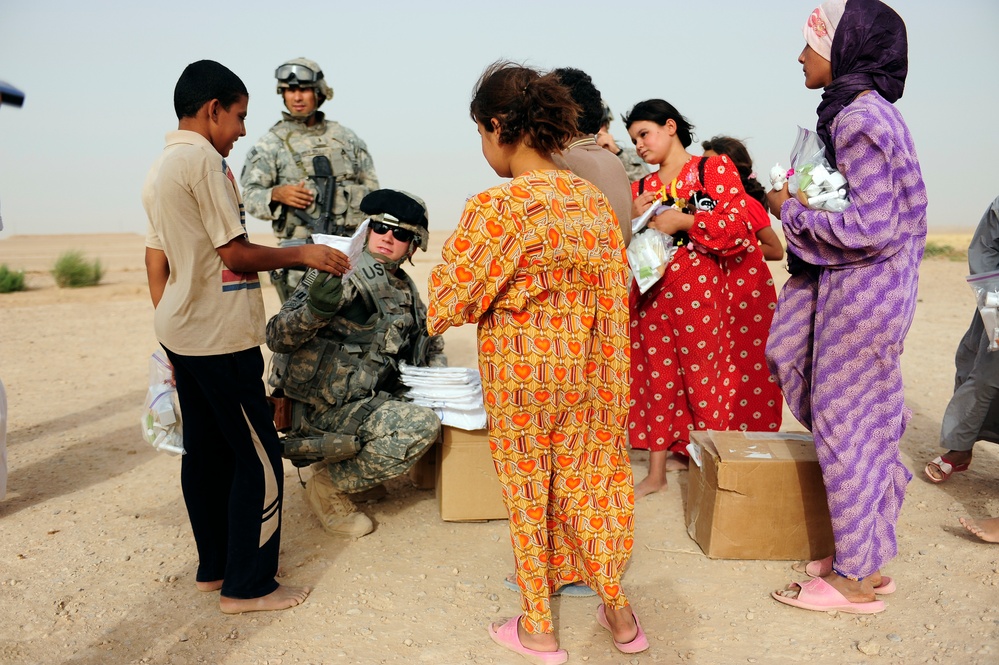 Soldiers hand out packages to locals