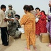 Soldiers hand out packages to locals