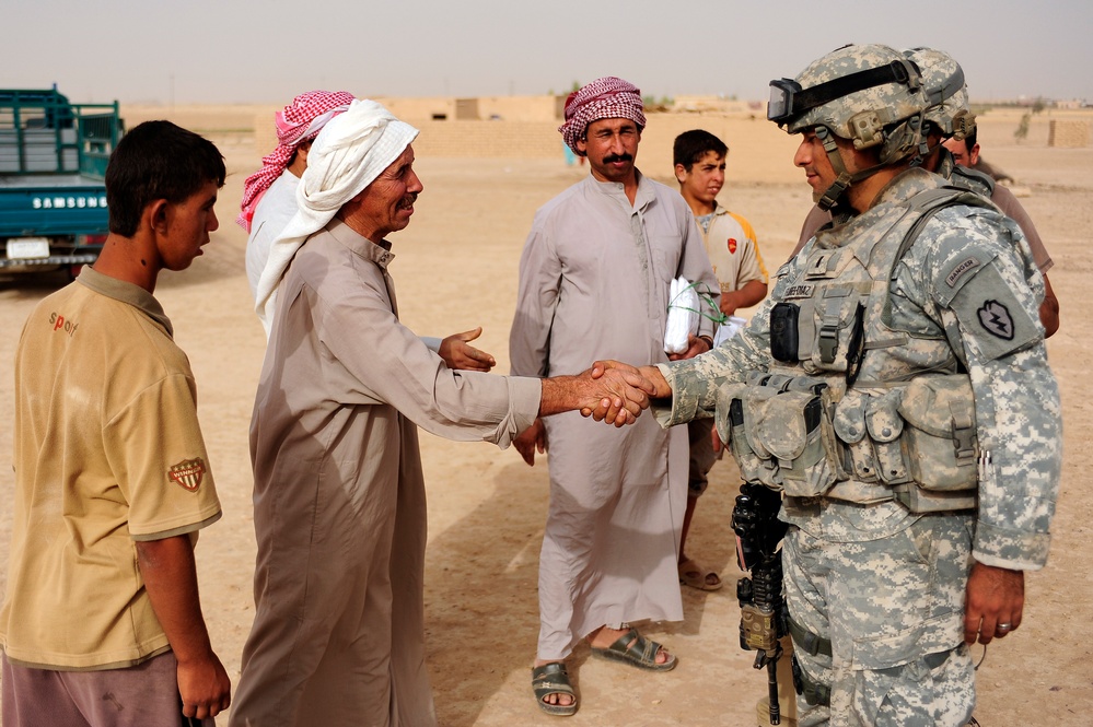 Soldiers hand out packages to locals