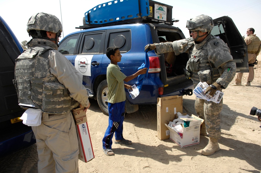 Soldiers hand out toys, check on police station project