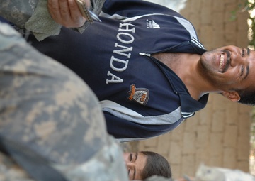 Iraqi soldiers give out food in Baghdad