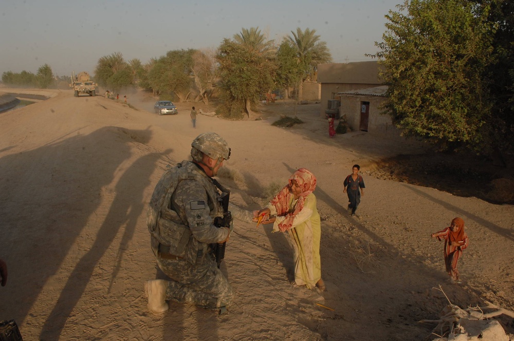 Iraqi soldiers give out food in Baghdad