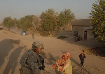 Iraqi soldiers give out food in Baghdad