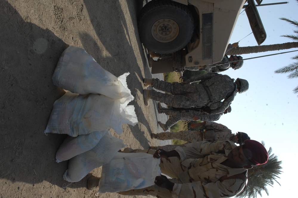 Iraqi soldiers give out food in Baghdad