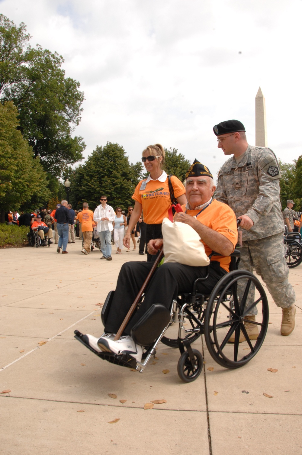 U.S. Army Soldier helps push a veteran's wheel chair at the World War II Memorial as part of Honor Flight, Sept. 16. Honor Flight is an organization where joint military forces help veterans tour throughout Washington D.C.