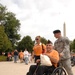 U.S. Army Soldier helps push a veteran's wheel chair at the World War II Memorial as part of Honor Flight, Sept. 16. Honor Flight is an organization where joint military forces help veterans tour throughout Washington D.C.