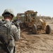 US troops repair a roadway near Iraq border