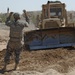 US troops repair a roadway near Iraq border