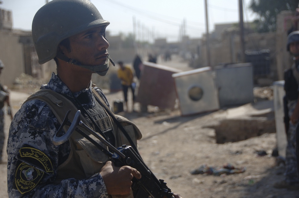 Soldiers; Iraqi police discover weapons cache