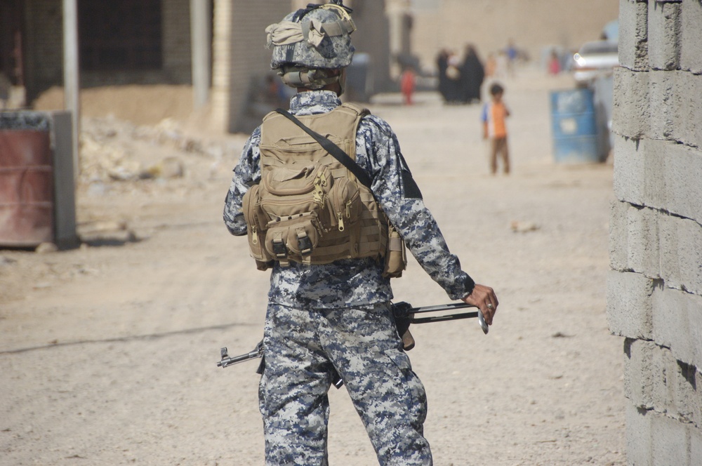 Soldiers; Iraqi police discover weapons cache