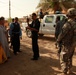 Iraqi soldiers hand out food in Tal Adh Dhah