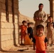 Iraqi soldiers hand out food in Tal Adh Dhah