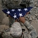Soldiers fold flag for reenlistment