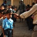 Soldiers give schoolchildren backpacks