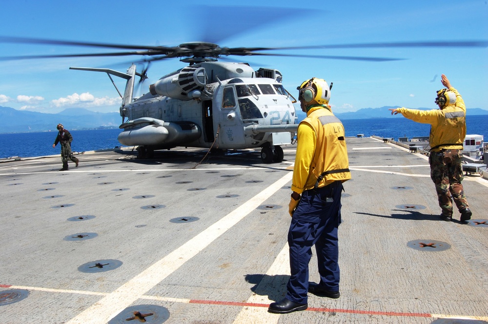 Sailors signal Marine helicopter