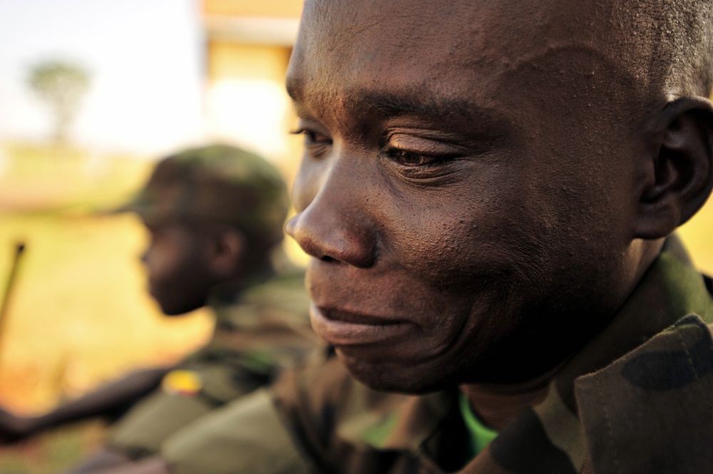 A Uganda Peoples Defense Force officer cadet sits in front of his barracks.