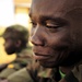 A Uganda Peoples Defense Force officer cadet sits in front of his barracks.