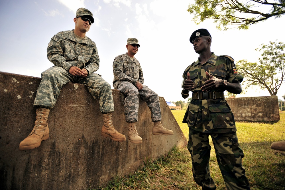 U.S. Soldiers attached to Combined Joint Task Force-Horn of Africa talk to a Uganda Peoples Defense Force Soldier in Jinja.