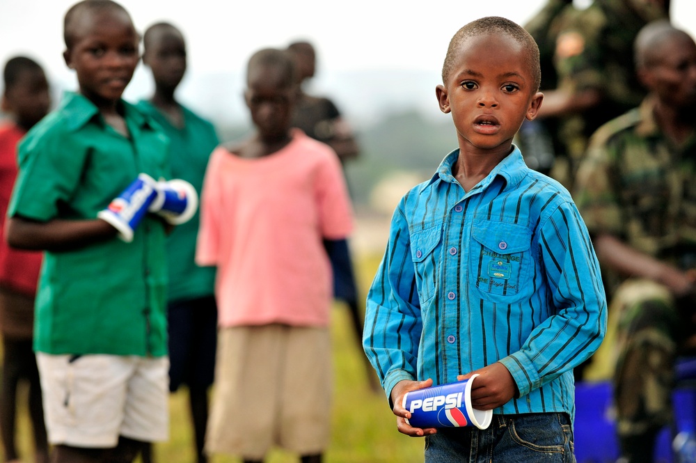 Children of Uganda Peoples Defense Force soldiers stand watching a graduation ceremony at the UPDF Non-Commissioned Officers Academy in Jinja.