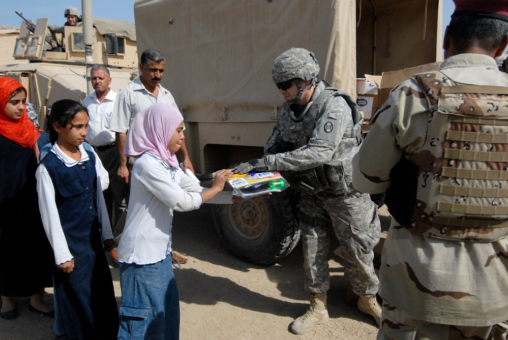 Soldiers deliver school supplies