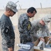 Iraqi policemen sort through equipment for sale, meet with soldiers and airmen