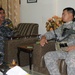 Iraqi policemen sort through equipment for sale, meet with soldiers and airmen