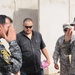 Iraqi policemen sort through equipment for sale, meet with soldiers and airmen