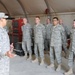 Iraqi policemen sort through equipment for sale, meet with soldiers and airmen