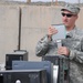Iraqi policemen sort through equipment for sale, meet with soldiers and airmen