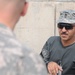 Iraqi policemen sort through equipment for sale, meet with soldiers and airmen
