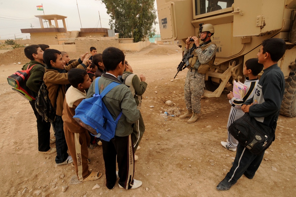 Soldiers inspect wells, visit children