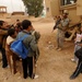 Soldiers inspect wells, visit children