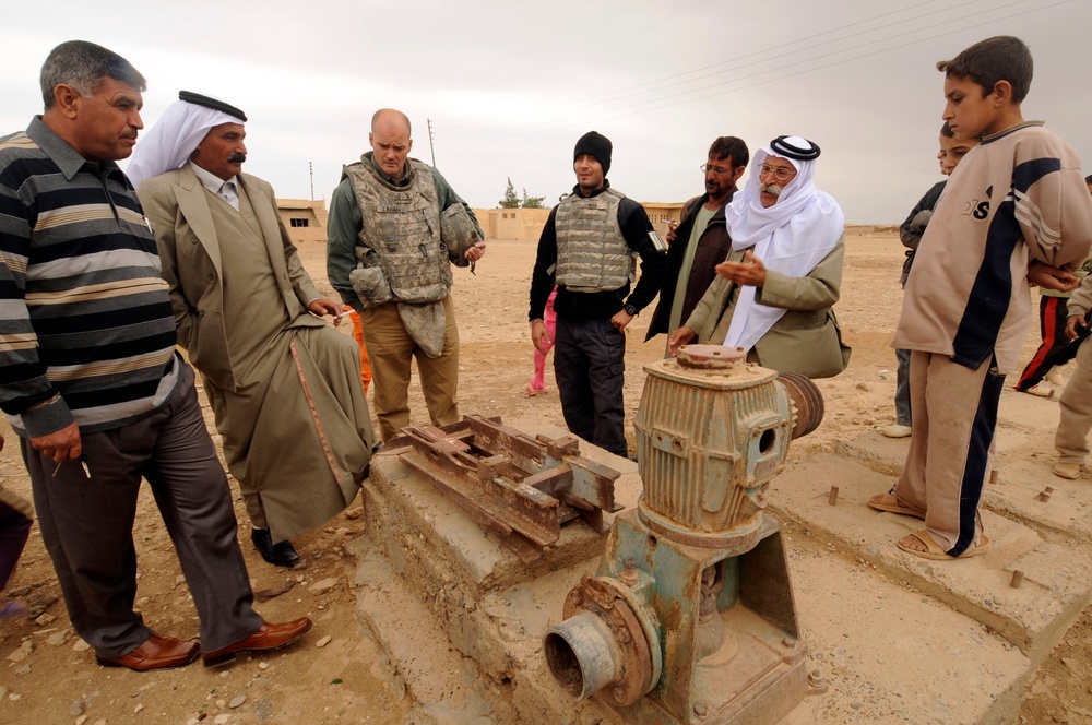 Soldiers inspect wells, visit children